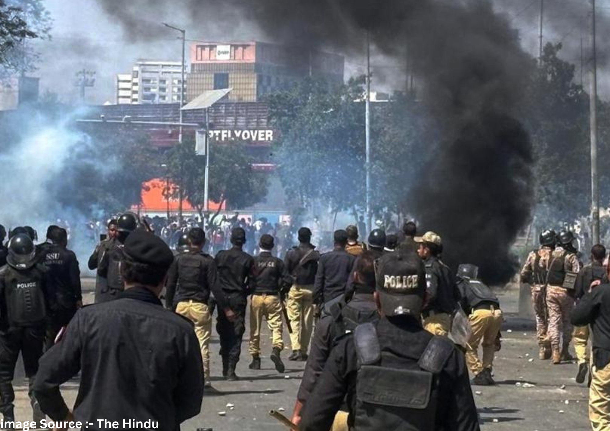 Police officers chase Shia Muslims blocking a road during a protest over the killing of Iranian Supreme Leader Ayatollah Ali Khamenei, in Karachi, Pakistan